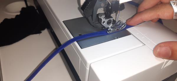 Préparation du liseré bleu. Il s'agit de biais bleu de 2 cm de large, plié en deux, et je le couds sur le côté afin qu'il demeure fermé.